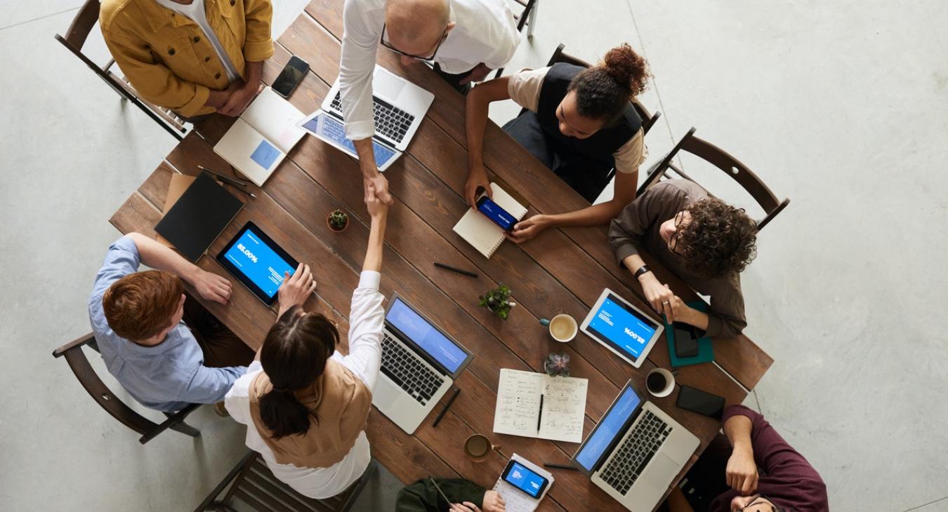 Handshake business meeting group table