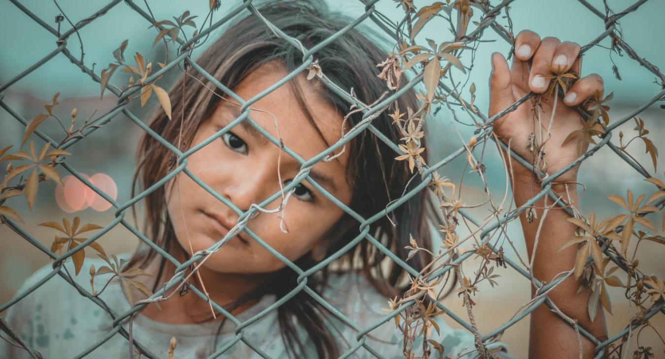 child by fence
